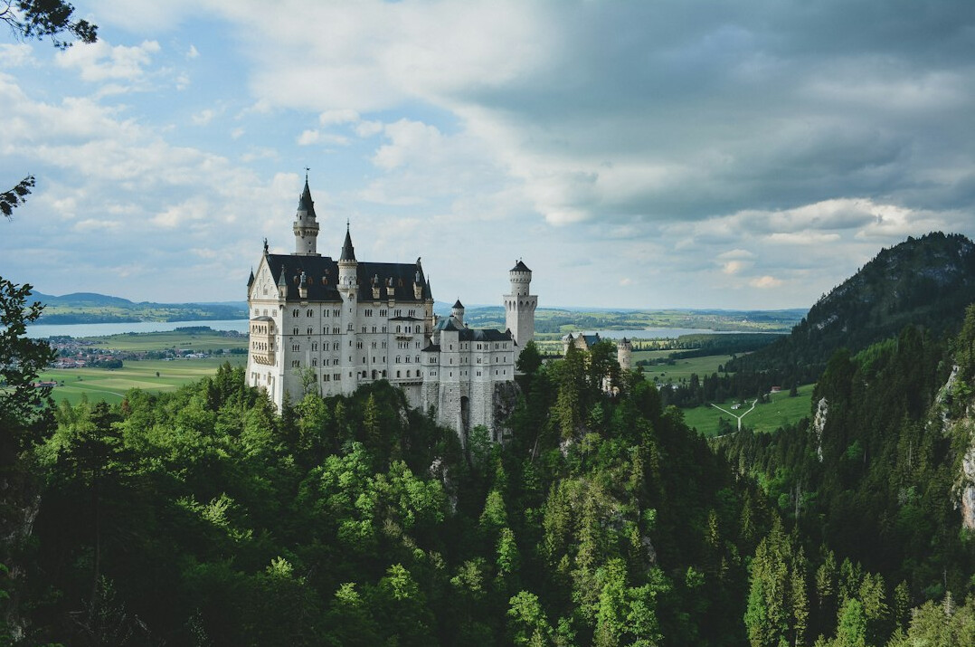 Ksiaz Castle perched on a cliff surrounded by autumn forest in Lower Silesia