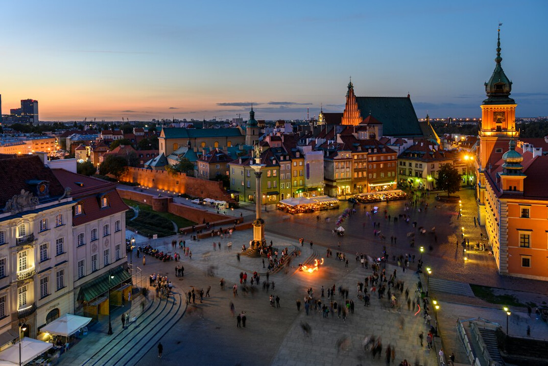 Main Market Square in Krakow at golden hour with Cloth Hall and St. Mary's Basilica