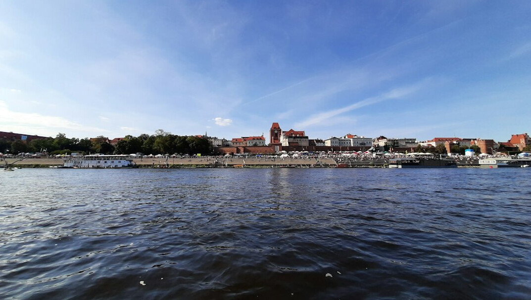 Torun medieval old town skyline across the Vistula river at dusk